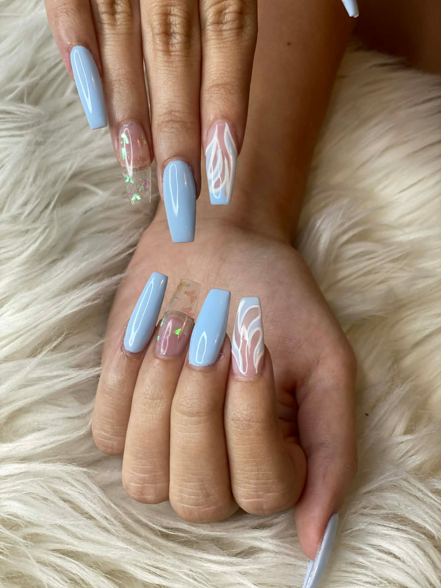 Baby blue coffin nails with butterfly and floral accents by AN Nail Spa