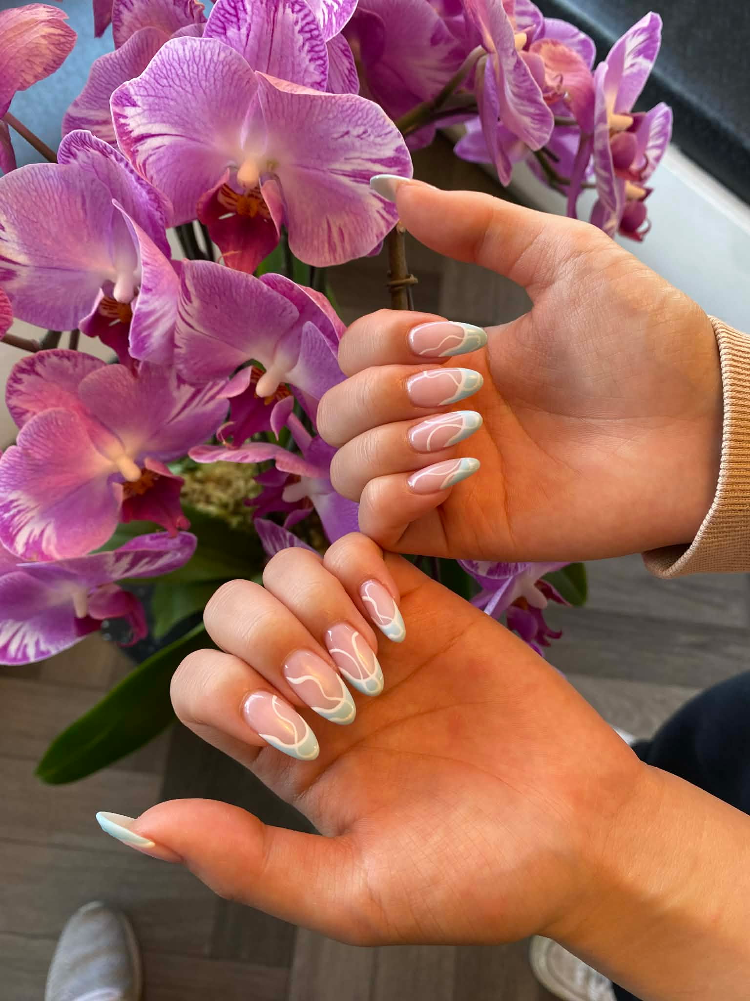 Elegant French tip nail art with swirl design by AN Nail Spa Toronto